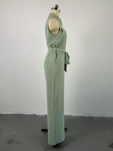 Side view of a mint green sleeveless lapel jumpsuit with wide-leg design and belt