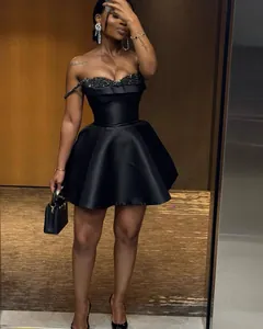 Elegant black strapless mini dress with shimmering sequin bust detail for party wear