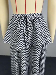 Close-up of black and white geometric pattern and tie-front waist on high-waisted A-line skirt