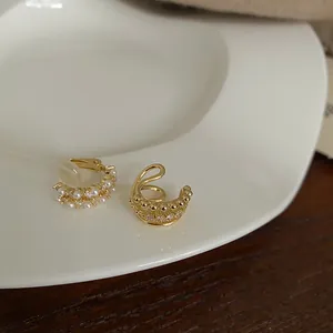 Elegant gold-tone pearl and rhinestone ear cuffs with clip-on backings for non-pierced ears