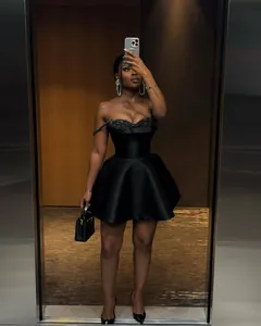 Elegant black strapless mini dress featuring a sequin bodice and a satin flare skirt