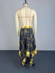 Macro detail of high-waisted yellow plaid skirt featuring irregular handkerchief hem.