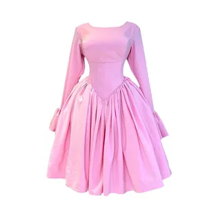 Elegant pink A-line dress with long sleeves and high waist design.