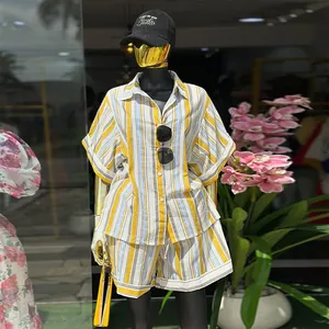 Stylish yellow striped two-piece set with a button-down shirt and high-waist shorts.