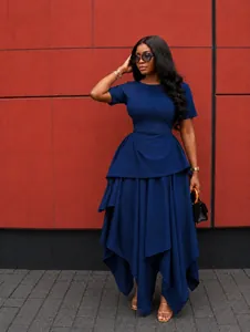 Elegant navy blue short sleeve maxi dress with irregular ruffled hem in outdoor setting