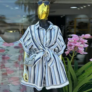 Detailed view of women's striped two-piece set featuring tied waist shirt and shorts