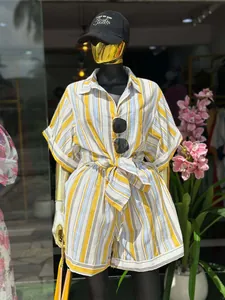 Detailed view of a sweet striped two-piece set featuring a tied waist shirt and shorts