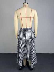 Rear view detail showing the irregular hem of a black and white gingham A-line skirt.