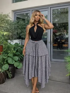 Full length lifestyle view of the black and white gingham midi skirt on a model