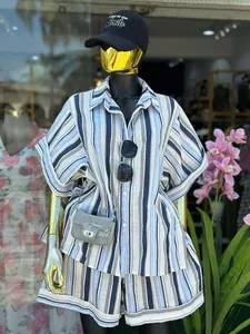 Fashionable two-piece blue and white striped shirt and shorts set on mannequin