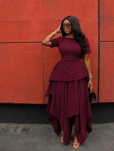 Full view of wine red asymmetrical dress with peplum waist and ruffled details