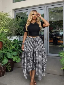 Stylish black and white houndstooth midi skirt featuring irregular hem and high waist tie
