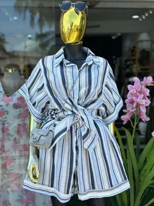 Detail of summer striped two-piece set featuring short sleeve shirt and high waist shorts