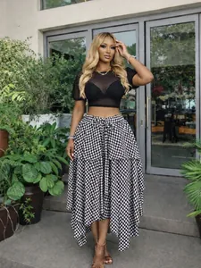 Stylish high-waisted black and white checkered irregular A-line midi skirt shown on model