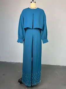 Elegant teal two-piece set with lantern sleeve crop top and pearl-beaded wide-leg pants