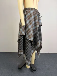 Side view detail of a stylish asymmetrical layered plaid skirt for summer fashion