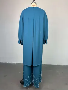 Rear view of teal two-piece set featuring a long tunic and beaded wide-leg pants.