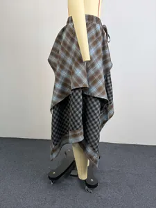 Side detail of irregular plaid skirt featuring mixed check patterns on mannequin