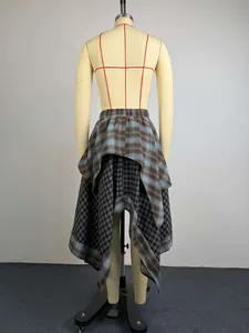 Rear view of irregular layered plaid skirt on mannequin with asymmetric hemline design.