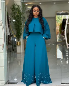 Elegant teal two-piece suit with lantern sleeves and beaded wide-leg pants detail