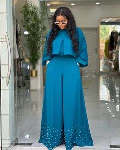 Elegant teal two-piece outfit featuring lantern sleeve top and beaded hem wide-leg pants