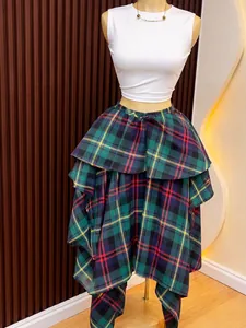 Detailed view of a green plaid high-waist irregular A-line tiered skirt on a mannequin