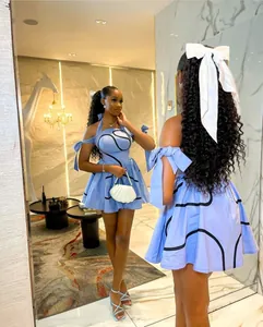 Detail of a light blue halter dress with black linear prints and off-shoulder straps.