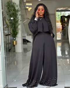 Stylish black two-piece set featuring irregular lantern sleeve top and pearl beaded pants