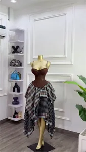 Full view of brown corset top and asymmetrical plaid skirt set on gold mannequin