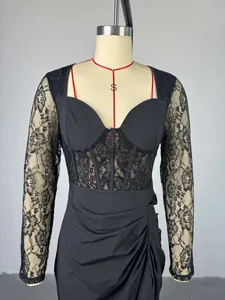 Detail of elegant black midi dress with lace sleeves and corset-style waistline