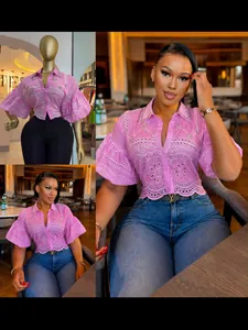 Close-up of pink hollow-out rhinestone shirt with stylish lantern sleeves and elegant eyelet detailing