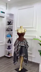 Close-up view of elegant brown corset top and asymmetrical layered plaid skirt set