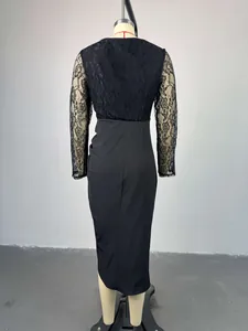Back view of a black midi dress with delicate floral lace long sleeves and high waist.