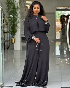 Full view of women's black set featuring lantern sleeve top and pearl hem wide-leg pants