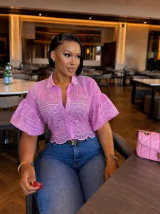 Close-up of pink hollow-out short shirt with rhinestone details and lantern sleeves