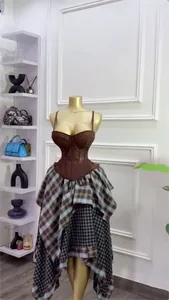 Two-piece summer fashion set with a brown corset top and asymmetrical plaid skirt