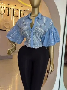 Blue short shirt with hollow out embroidery and rhinestone details and lantern sleeves.