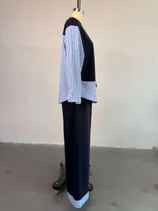 Side view of fashion striped patchwork set with crewneck top and high waist trousers.