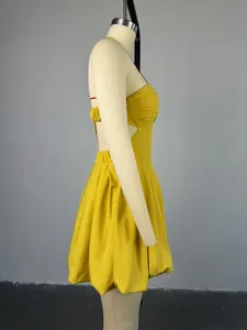 Detailed side view of yellow halter backless high waist mini dress shown on mannequin
