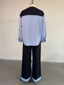 Back view of a stylish striped patchwork long-sleeve top and high-waisted pants outfit