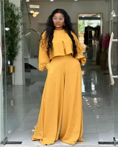 Elegant yellow two-piece set featuring lantern sleeve top and pearl beaded wide-leg pants