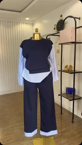Stylish navy blue two-piece set with striped splicing, displayed on a gold mannequin