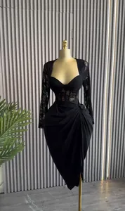 Elegant black midi dress with long lace sleeves and draped skirt detail.