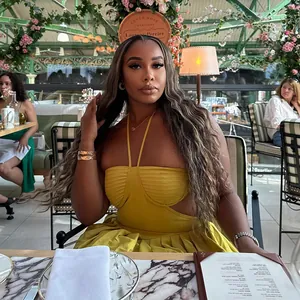 Detail shot of a mustard yellow halter-neck backless dress in a stylish restaurant setting