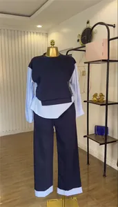 Stylish two-piece navy blue casual set with striped patchwork on a gold mannequin.