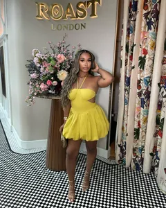 Elegant yellow halter-neck backless mini dress with a pleated puff skirt design.