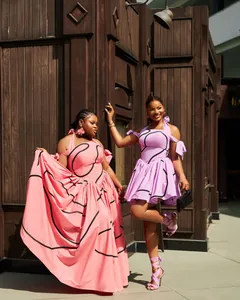 Elegant halter neck summer dresses in pink and lavender with modern black line prints