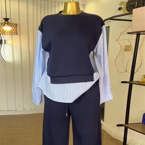 Close-up of a two-piece casual set featuring a blue patchwork striped top and matching pants.