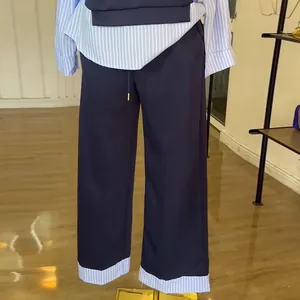 Close-up detail showing the fashionable navy blue and striped patchwork casual set for women