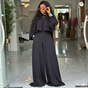 Elegant black two-piece outfit featuring lantern sleeve top and beaded wide-leg pants